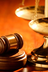 Gavel and block beside the scales of justice